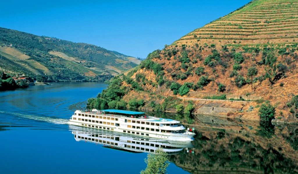 Passeio de barco no rio Douro entre as vinhas em socalcos